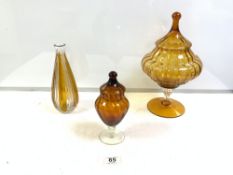 AMBER GLASS FOOTED BOWL AND COVER 24CM WITH A SMALLER JAR AND COVER AND AN AMBER GLASS DECANTER