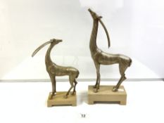 A PAIR OF ART DECO STYLE SILVERED COMPOSITION MODELS OF ANTELOPES (THE LARGEST 44CMS)