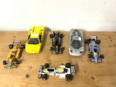 FOUR FORMULA ONE TOY CARS BY BURAGO AND TWO SPORTS CARS BY MAISTO