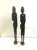 A PAIR OF TALL AFRICAN-CARVED HARDWOOD FIGURES OF MAN AND WOMAN 76 CM