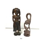 A RESIN FIGURE OF A LADY HOLDING HER HAIR 37 CMS WITH A CARVED WOODEN LADY FIGURE 43 CM HIGH