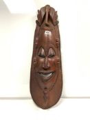 A LARGE RED WOOD CARVED MASK WITH ELEPHANT, FACE AND BLACK PIGMENT, DETAIL FROM BOTSWANA, 71CMS