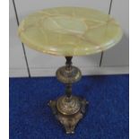 A gilded metal occasional table the baluster leaf chased stem supporting an onyx top on leaf mounted