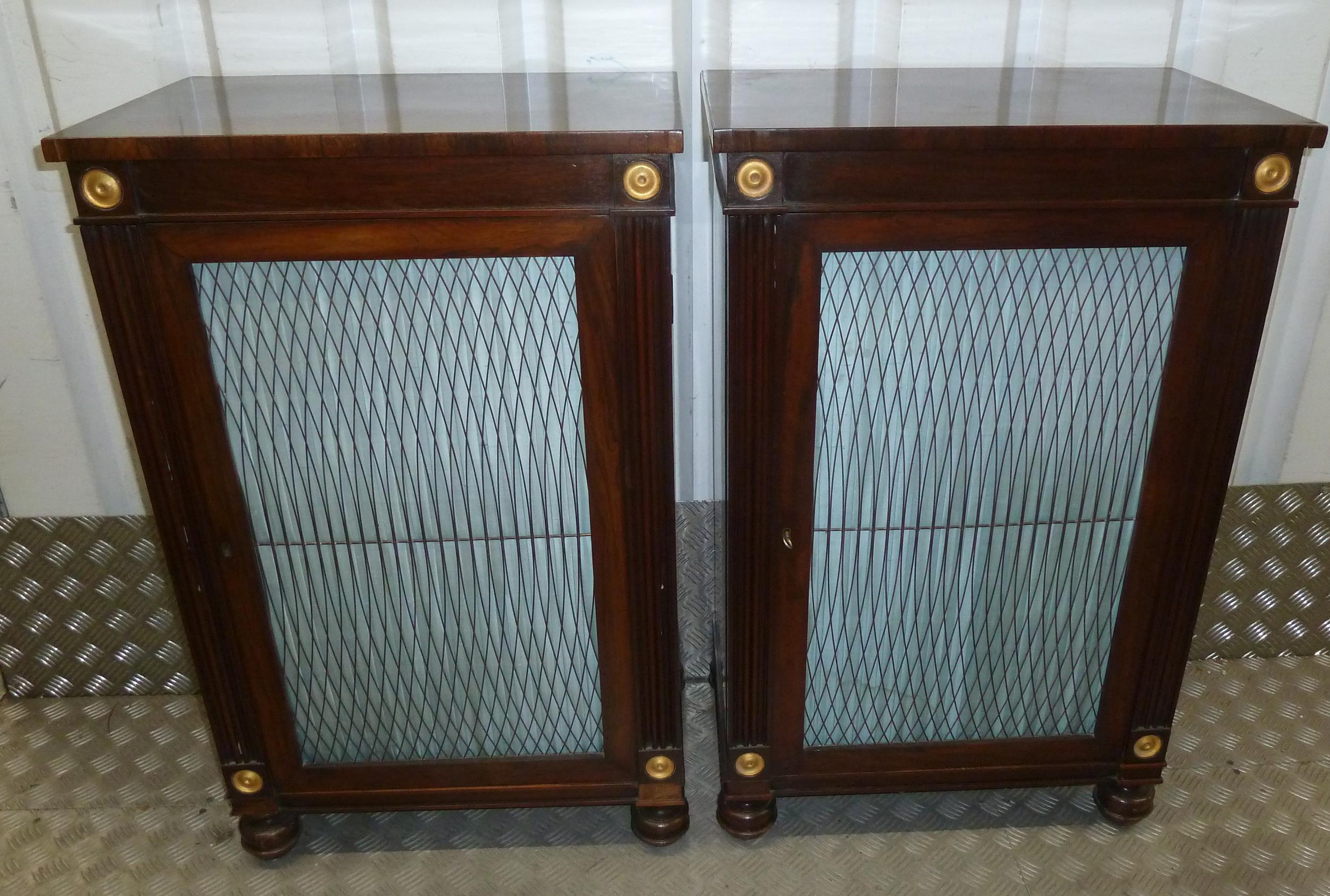 A pair of Regency mahogany rectangular cabinets with hinged doors on four turned bun feet, 88 x 56 x