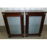 A pair of Regency mahogany rectangular cabinets with hinged doors on four turned bun feet, 88 x 56 x