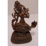 Tibetan gilded bronze figurine of Buddha on carved and pierced lotus base, 28cm (h)