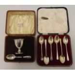 A cased set of hallmarked silver coffee spoons and a cased eggcup and spoon set