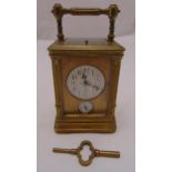 A brass repeating carriage clock by Dent of the Strand, rectangular form with white enamel dial