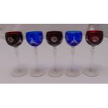 Five cut glass coloured hock glasses on circular spreading bases