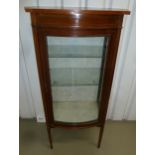 An Edwardian rectangular display cabinet, glazed hinged bow fronted door on four tapering