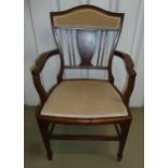 An Edwardian mahogany occasional chair with inlaid decoration, upholstered seat and back on tapering