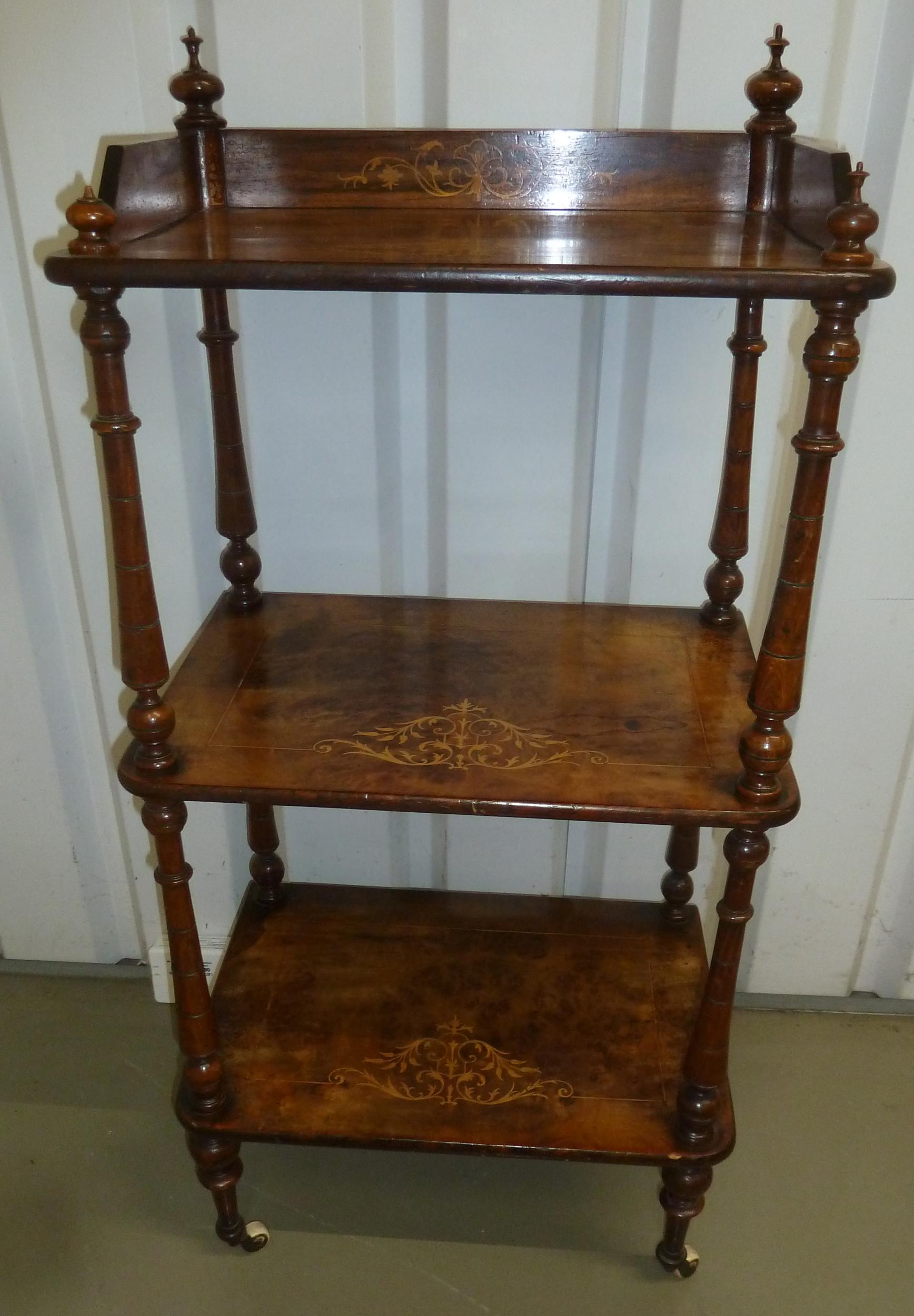 A Victorian rectangular mahogany three tier whatnot with turned cylindrical side columns and legs,