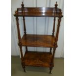 A Victorian rectangular mahogany three tier whatnot with turned cylindrical side columns and legs,