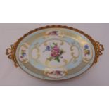 A Limoges oval centre piece decorated with flowers, scrolls and applied gilded metal gallery and