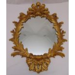 A Rococo style wall mirror shaped oval with gilded pierced leaf border, 106 x 74.5cm