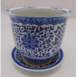 A Chinese blue and white jardinière on stand of cylindrical form decorated with stylised flowers and