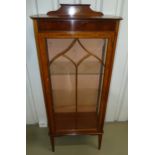 An Edwardian rectangular display cabinet, glazed hinged door on four tapering rectangular legs,