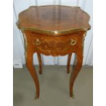 An inlaid mahogany rectangular side table with gilded metal mounts and a single drawer on four