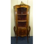 A late 19th century French Kingswood and gilt metal vitrine with bowed glass hinged door above a