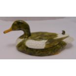 A polychromatic well modelled porcelain figurine of a duck, retailed by Casa Pupo, marks to the