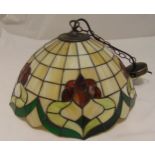 A Tiffany style ceiling lamp shade decorated with stylised flowers and leaves, 48cm (d)