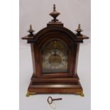 A late 19th century mahogany bracket clock, architectural form, silvered chapter ring with Roman