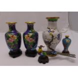 A quantity of oriental Cloisonné vases to include four vases and a stylised peacock on hardwood