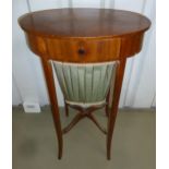 A shaped oval mahogany sewing table with single drawer on four tapering rectangular outswept legs,