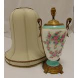 A porcelain and gilt metal table lamp, decorated with floral garlands, side handles on raised