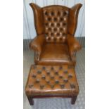 A leather wingback armchair with matching foot stool on four rectangular legs