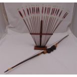 A novelty Mesoamerican wooden bow and arrow set