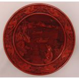 Chinese circular cinnabar lacquer plate carved with boats, flowers and leaves, 26cm (d)
