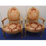 A pair of 19th century continental upholstered salon chairs, the legs, arms and backs carved with