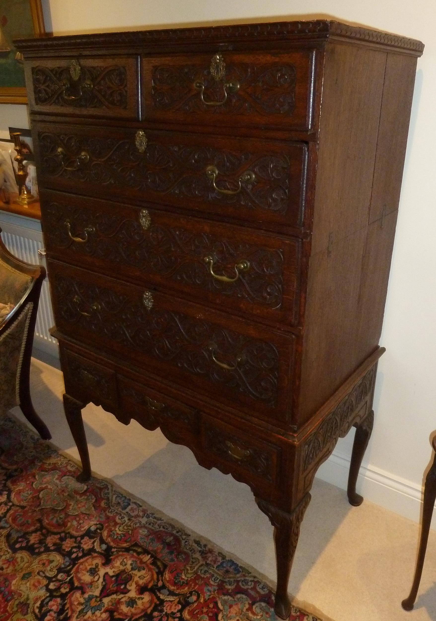 An early oak rectangular chest on stand, leaf and scroll carved drawers with brass swing handles - Image 2 of 2