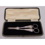 A pair of hallmarked silver grape scissors, reed and shell borders, Sheffield 1937 in original