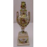 A continental urn and cover of classical form, decorated with flowers and scenes of courting couples