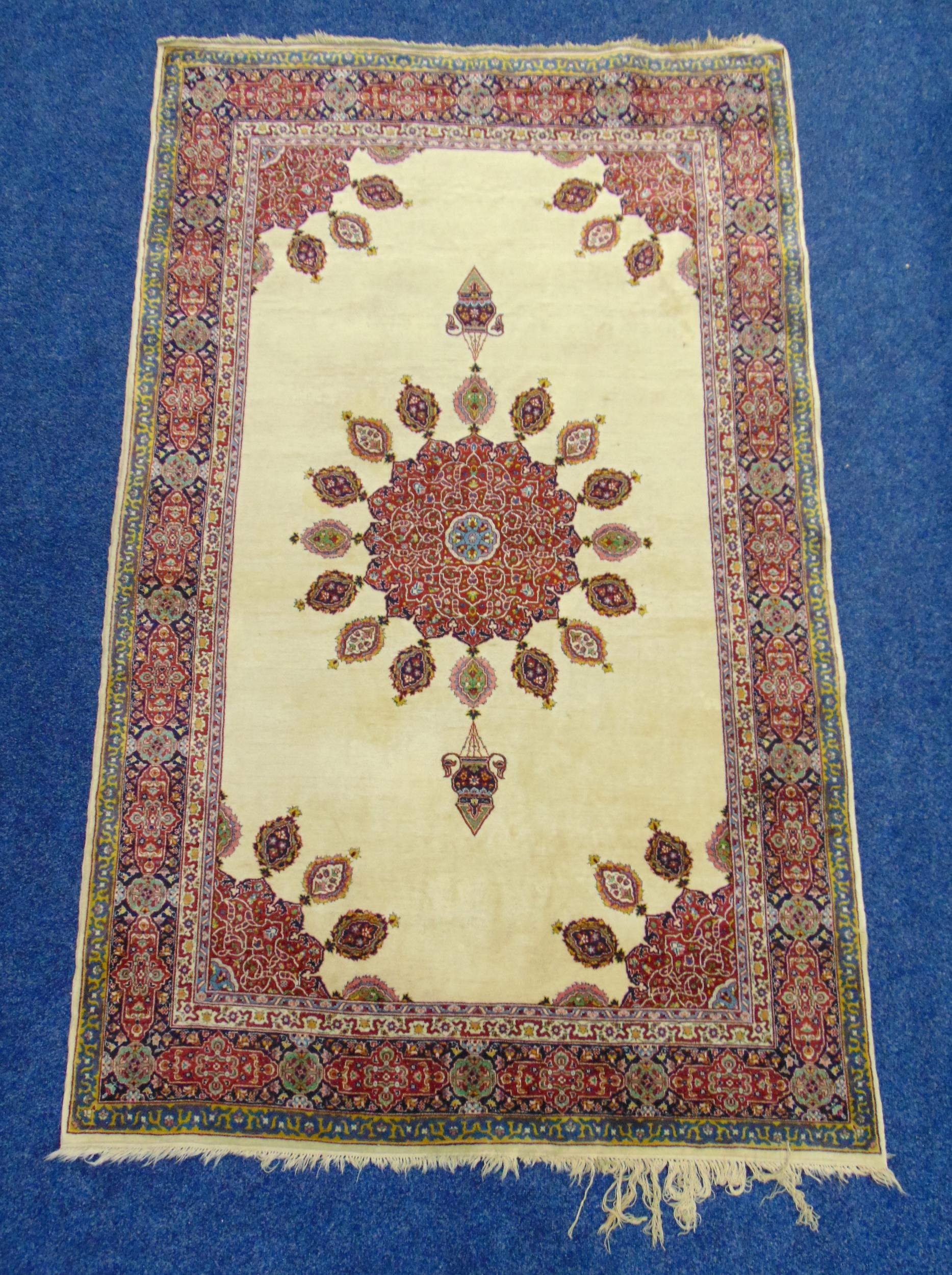 A Middle Eastern wool carpet cream ground with red and blue border, 219 x 136cm
