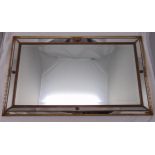 A rectangular wall mirror, the bevelled plate within raised gilded beaded borders, 68 x 116cm