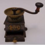 An early 20th century cast iron rectangular coffee grinder with turned wooden handle and single