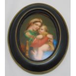 A German 19th century hand painted wall plaque after Raphael of Madonna and Child in oval frame,