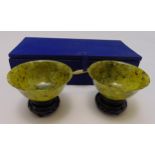 A pair of jadeite bowls on carved hardwood stands in original fitted case