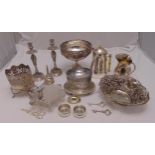 A quantity of silver plate to include a pair of candle sticks, a biscuit barrel and a wine funnel