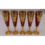 Five cranberry coloured glass wine glasses, hand painted with flowers and leaves on raised