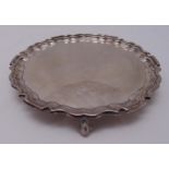 A Mappin and Webb hallmarked silver card tray with double scroll border on three scroll feet,