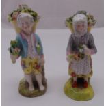 A pair of Meissen style figurines of a boy and girl carrying baskets of flowers, cross swords mark