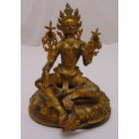 A Tibetan gilded metal figurine of Tara Tibet on shaped oval base, 24.5cm (h)