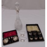 A cased set of hallmarked silver napkin rings, a cased set of hallmarked salts, two bottle labels