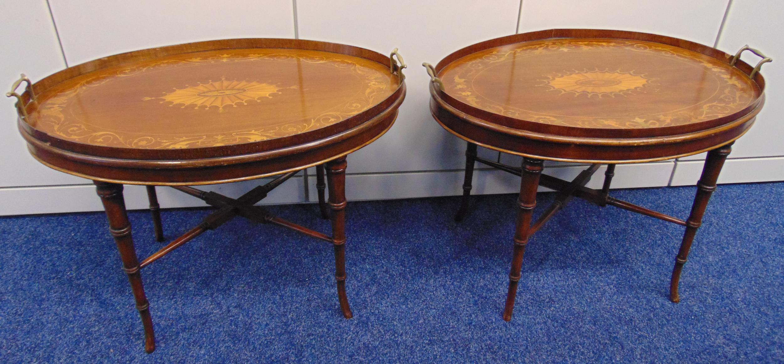 A pair of Edwardian oval mahogany inlaid tea tray tables, on simulated bamboo stands, 61 x 67.5 x