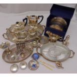 A quantity of silver plate to include a teaset, trays, placemats, condiments and a toast rack