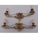 A pair of gilt metal two branch wall lights
